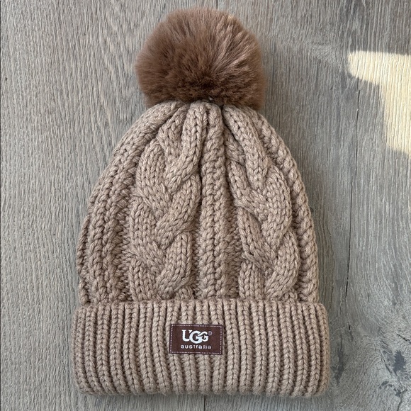 UGG Accessories - NWOT UGG Australia Taupe Chunky Cable Knit Fleece Lined Brown Faux Fur Pom Hat